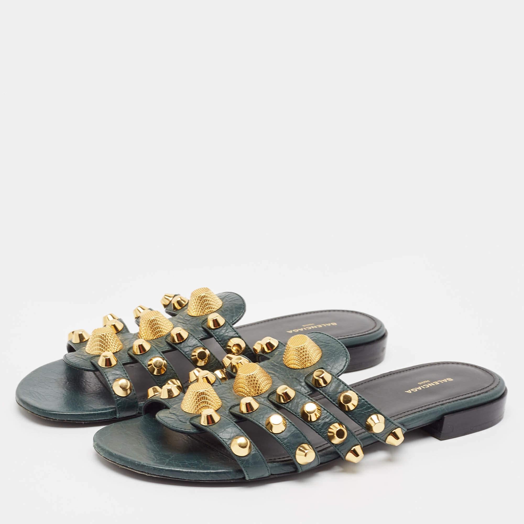 Keep it casual and chic with these green flats from Balenciaga. They have been crafted from durable leather styled with gold tone studs on the straps and completed with comfortable insoles.