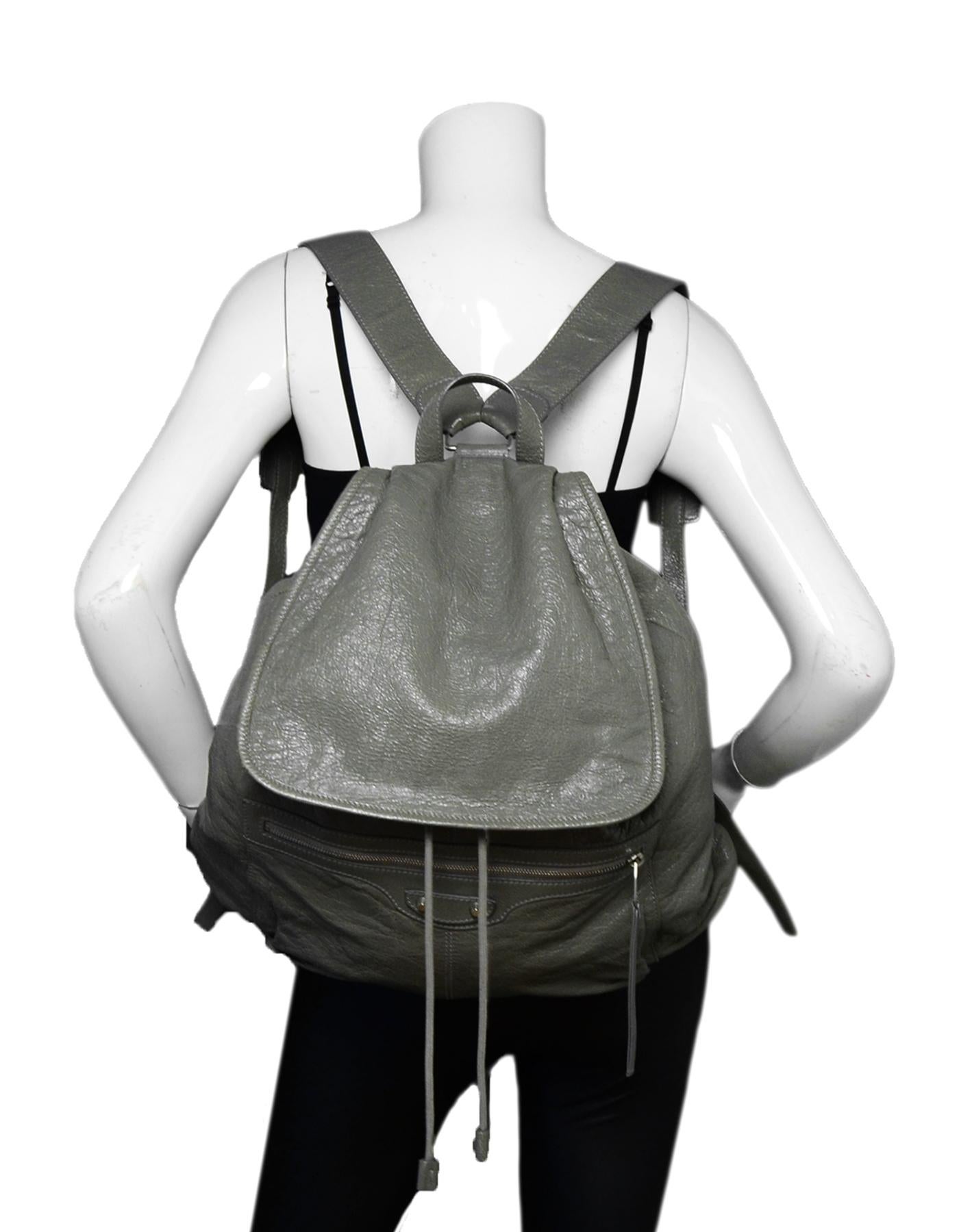 Balenciaga Grey Agneau Leather Classic Traveler S Backpack Bag  rt $1,615

Made In: Italy
Color: Grey
Hardware: Silvertone hardware
Materials: Leather
Lining: Black textile lining
Closure/Opening: Top flap with buckle closure
Exterior Pockets: One
