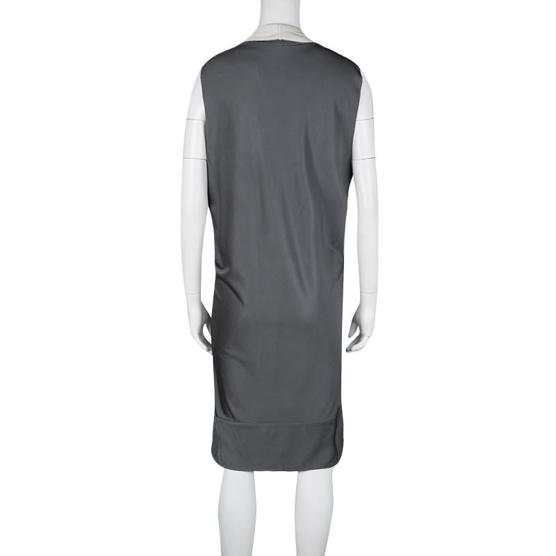 A gorgeous dress for a woman who likes versatility in her clothes, be it for a formal gathering or a casual outing with some friends. This dress by Balenciaga comes in a lustrous grey with a bold cowl neck detail. The straight fit sleeveless dress