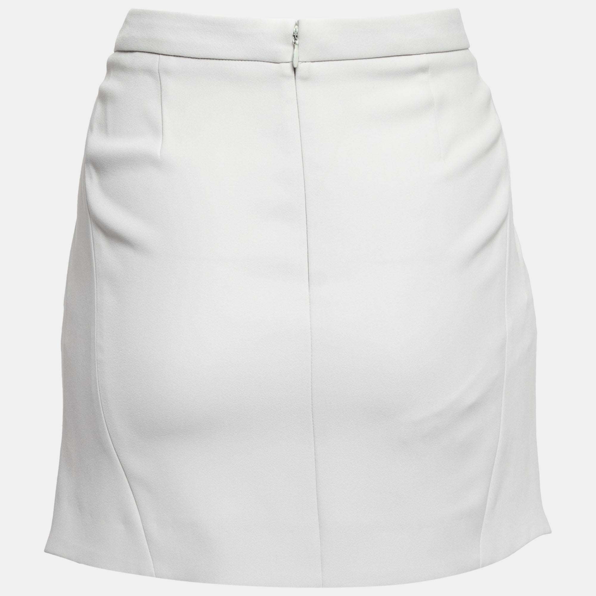 This mini skirt from Balenciaga will deliver a sense of femininity and beauty to your attire. It is made from grey crepe fabric and is enhanced with pleated formations. It is provided with a zipper closure at the back. Match this skirt with your