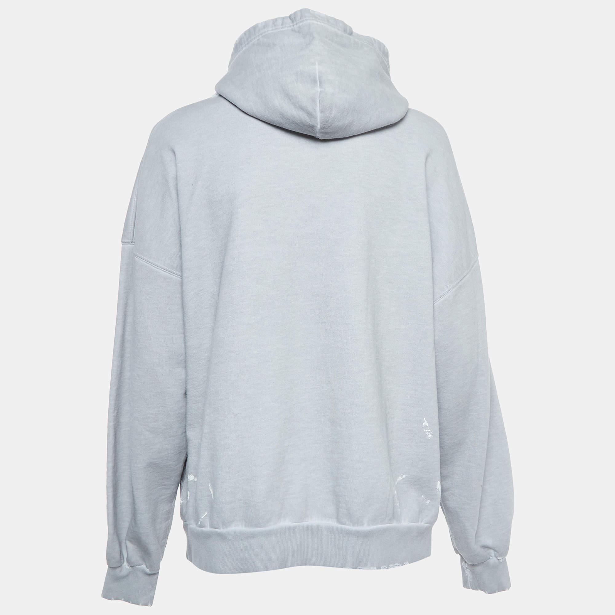 The Balenciaga hoodie is a stylish and edgy wardrobe essential. Crafted from high quality cotton it features a distressed design for a worn in look. The graphic print adds a contemporary flair making it a versatile and fashion forward piece.