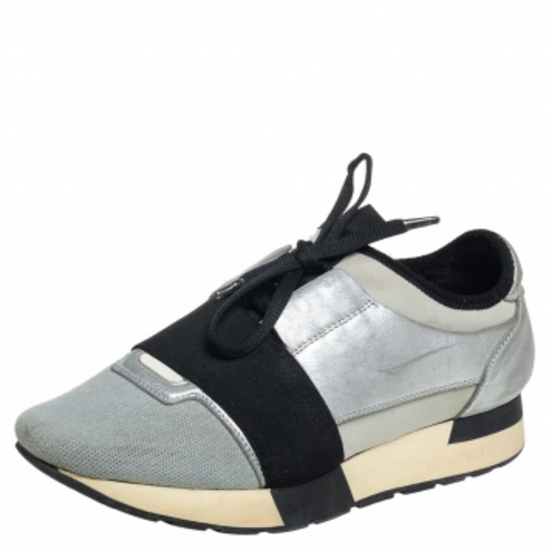 Let your latest shoe addition be this pair of Balenciaga Race Runners sneakers. These sneakers have been crafted from leather and knit fabric and feature a chic silhouette. They flaunt covered toes, strap detailing on the vamps, and tie-up