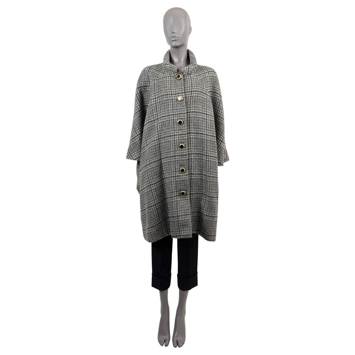 100% authentic Balenciaga plaid coat in cream, grey and black wool (60%) and mohair (40%). Features an oversized silhouette, two slit pockets at the waist and 7/8 raglan sleeves (sleeve measurement taken from the neck). Opens with gold-tone and
