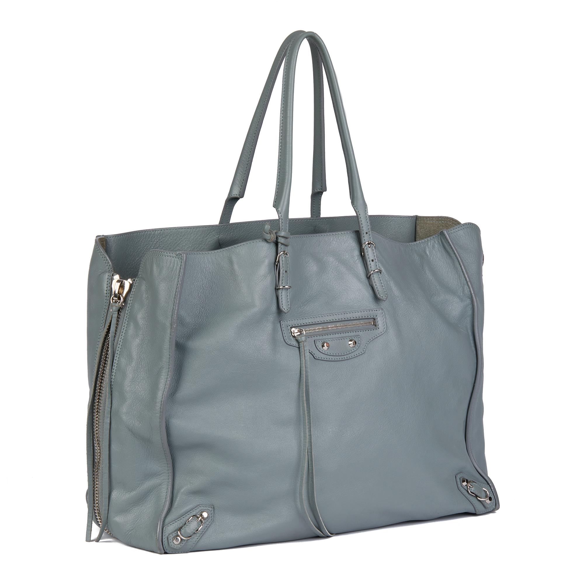 BALENCIAGA
Gris Glace Lambskin Zip Around Papier A4 Tote

Serial Number: 357331-1310-G-1669
Age (Circa): 2015
Accompanied By: Mirror
Authenticity Details: Serial Stamp (Made in Italy)
Gender: Ladies
Type: Tote, Shoulder, Shopper

Colour: Gris Glace