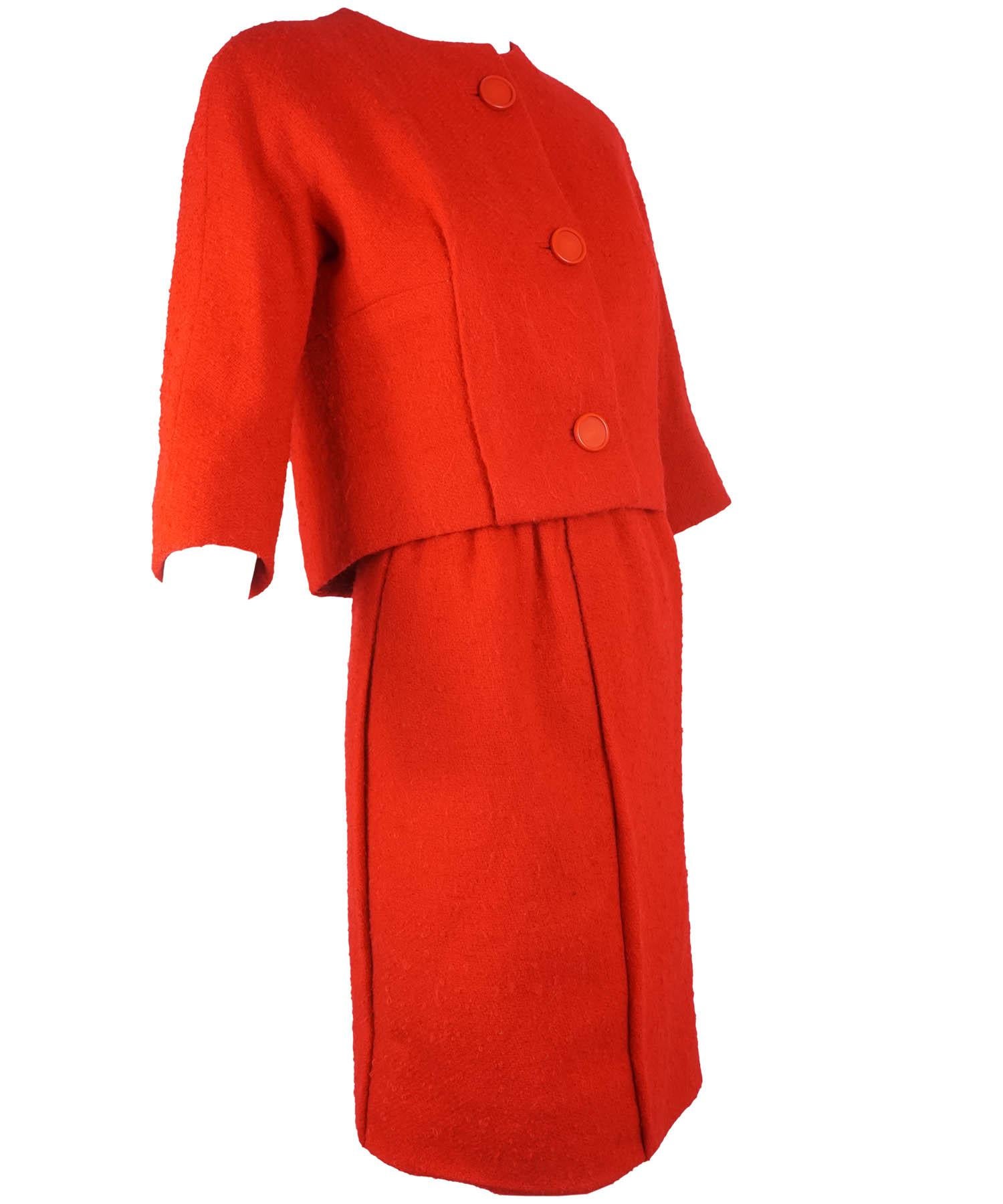 Balenciaga Haute Couture vintage Skirt suit from the 1950s, features three individual pieces composed of red wool boucle boxy jacket with three large color matching buttons at the front, a knee length skirt with off center back seam zipper button