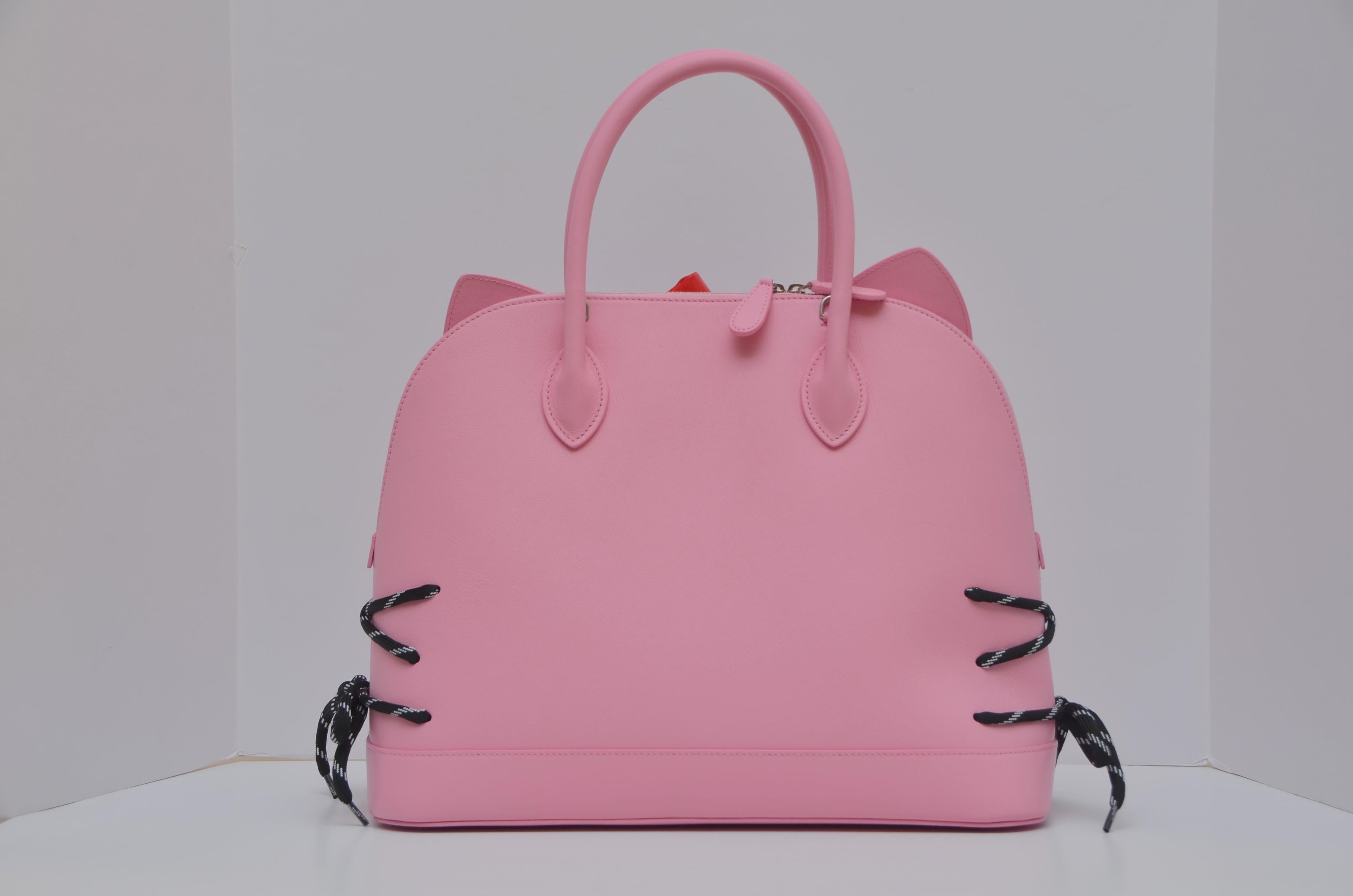 Balenciaga HELLO KITTY Baby Pink color Ville Handbag With Strap and tags  
Rare and limited size.
Designed in collaboration with Hello Kitty, Balenciaga's bag is complete with ears, a bow and whiskers, which are created using the laces from the