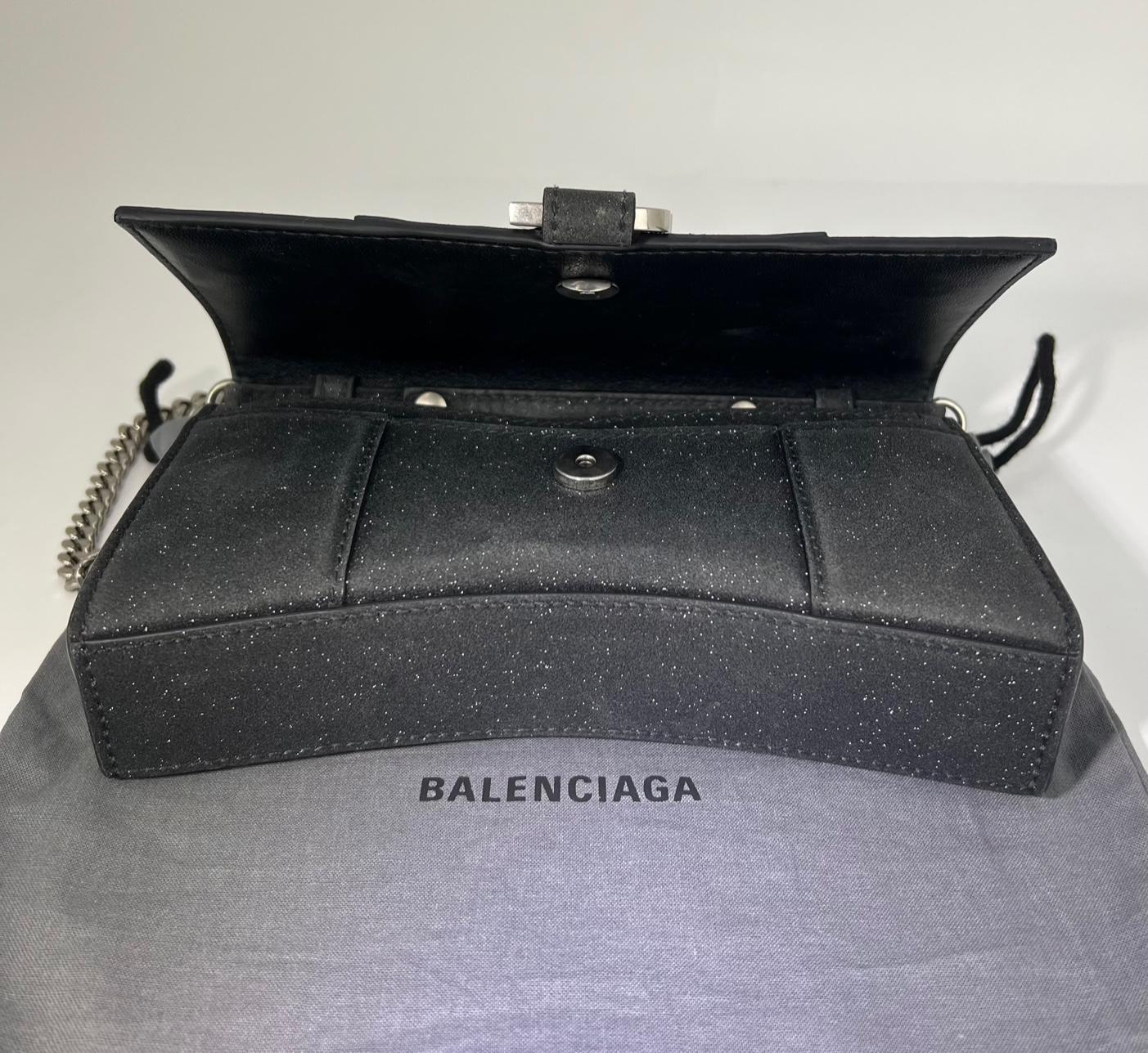 Pre-Owned  100% Authentic
BALENCIAGA Hourglass Wallet On Chain Black Glitter
THIS IS NOT THE XS (its bigger)
RATING: A/B...Very Good, well maintained, 
shows minor signs of wear
MATERIAL: glitter fabric, leather
STRAP: adjustable, removable chain