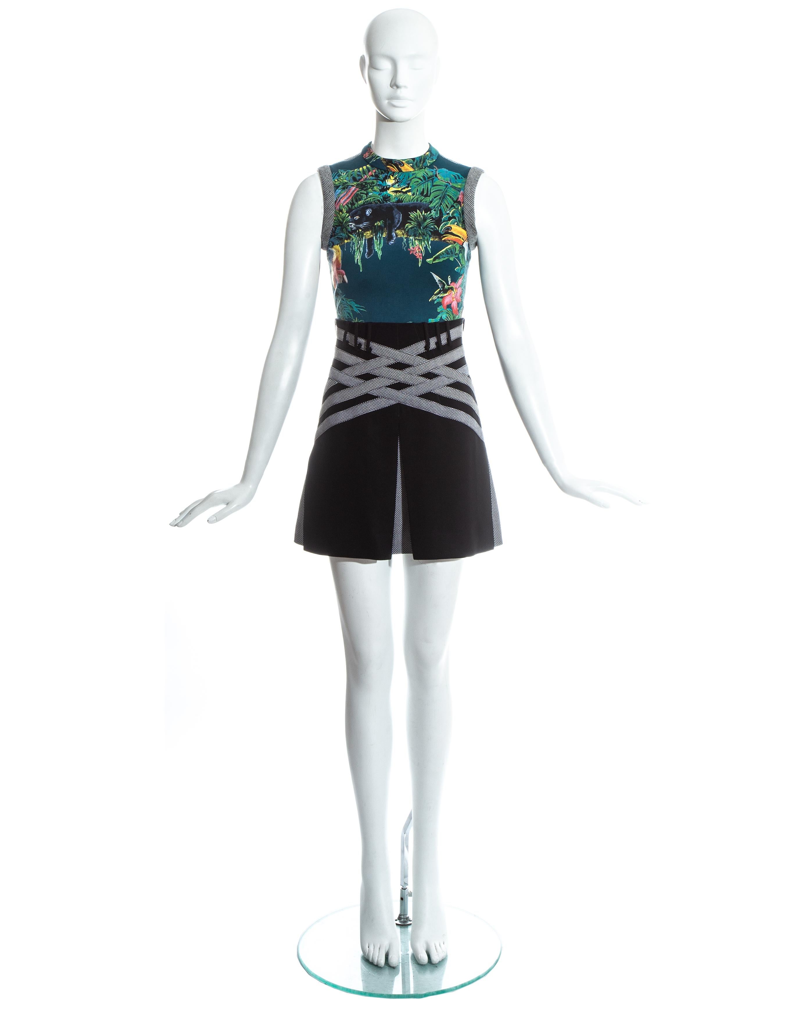 Balenciaga by Nicolas Ghesquière; teal fitted vest with jungle themed print and back zip fastening. Black high waisted mini skirt with box pleats and checked pattern . Worn together as an ensemble and seperately on the runway.   

Spring-Summer 2003
