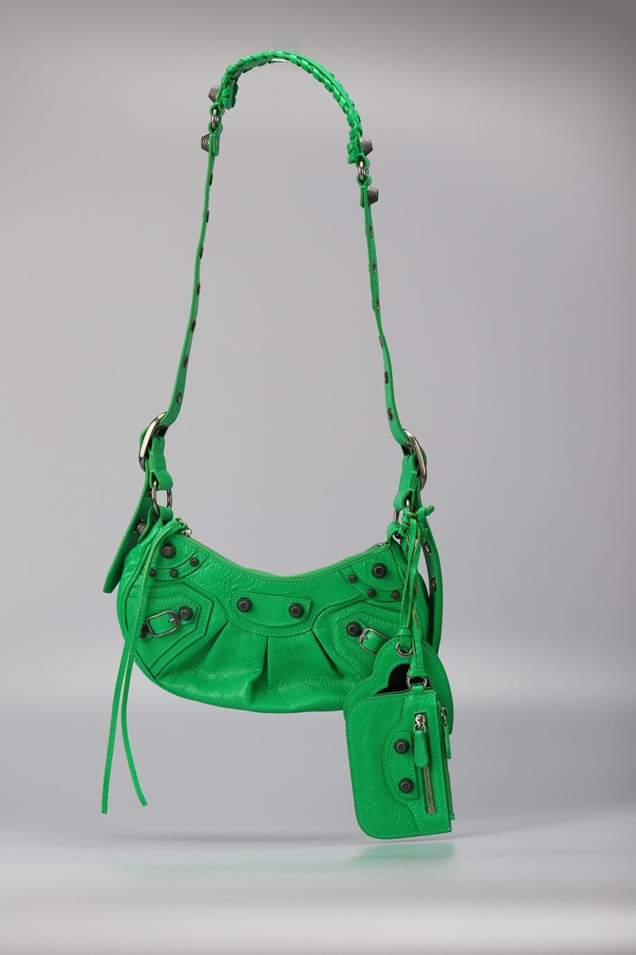 Balenciaga Le Cagole Xs Studded Crinkled Leather Shoulder Bag. Green. Zip fastening - Top. Does not come with - dustbag or box. Height: 5 In. Width: 9.5 In. Depth: 2.1 In. Strap drop: 15.3 In. Condition: Used. Very good condition - Worn once. No