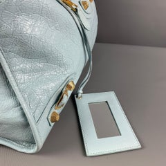 BALENCIAGA Hellblaue, goldfarbene Ledertasche mit Beschlägen