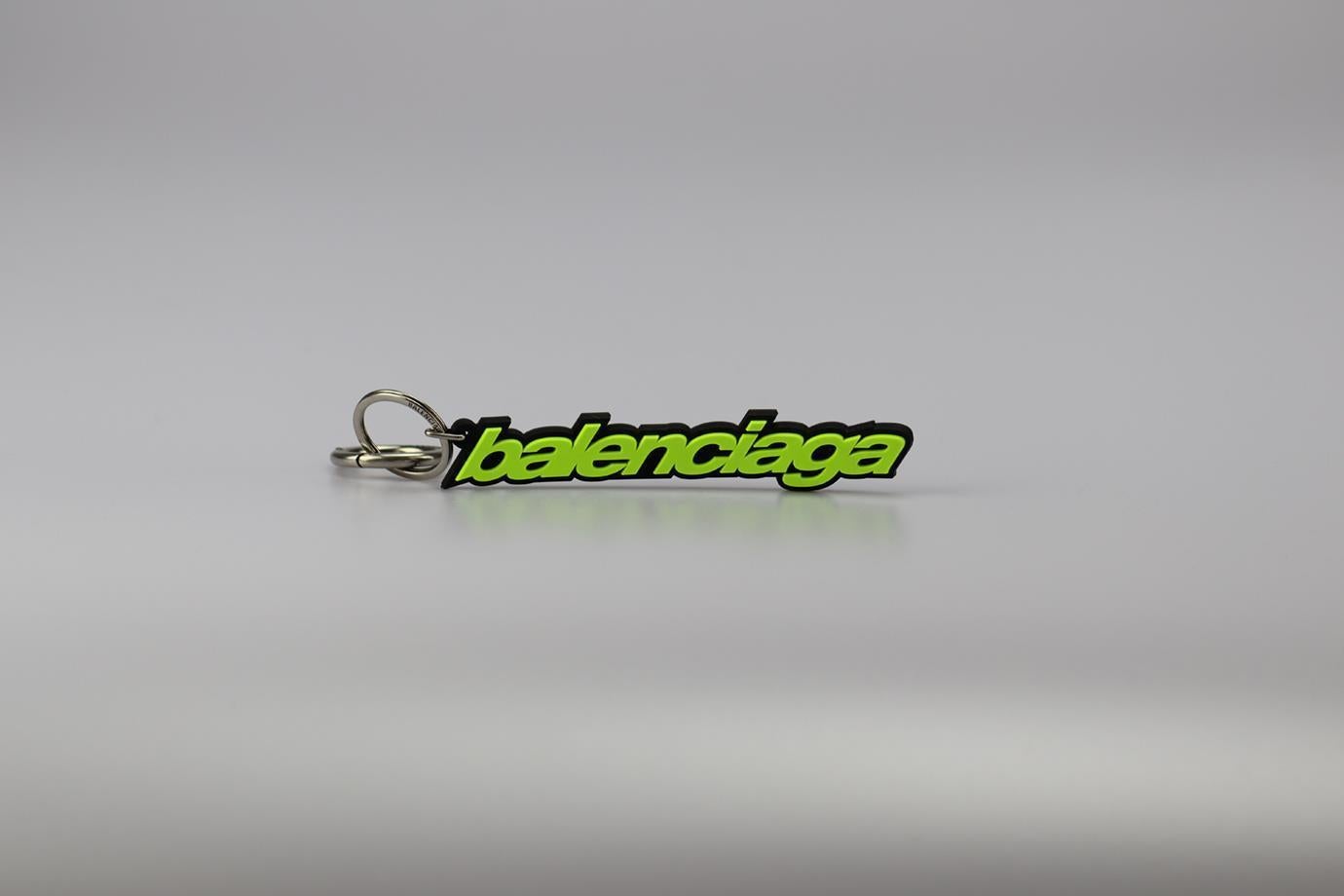 Balenciaga Logo Detailed Rubber Keychain. Neon-green and black. Buckle fastening - Back. Does not come with - dustbag or box. Height: 0.7 In. Width: 5.7 In. Depth: 0.2 In. Condition: Used. Very good condition - No sign of wear; see pictures