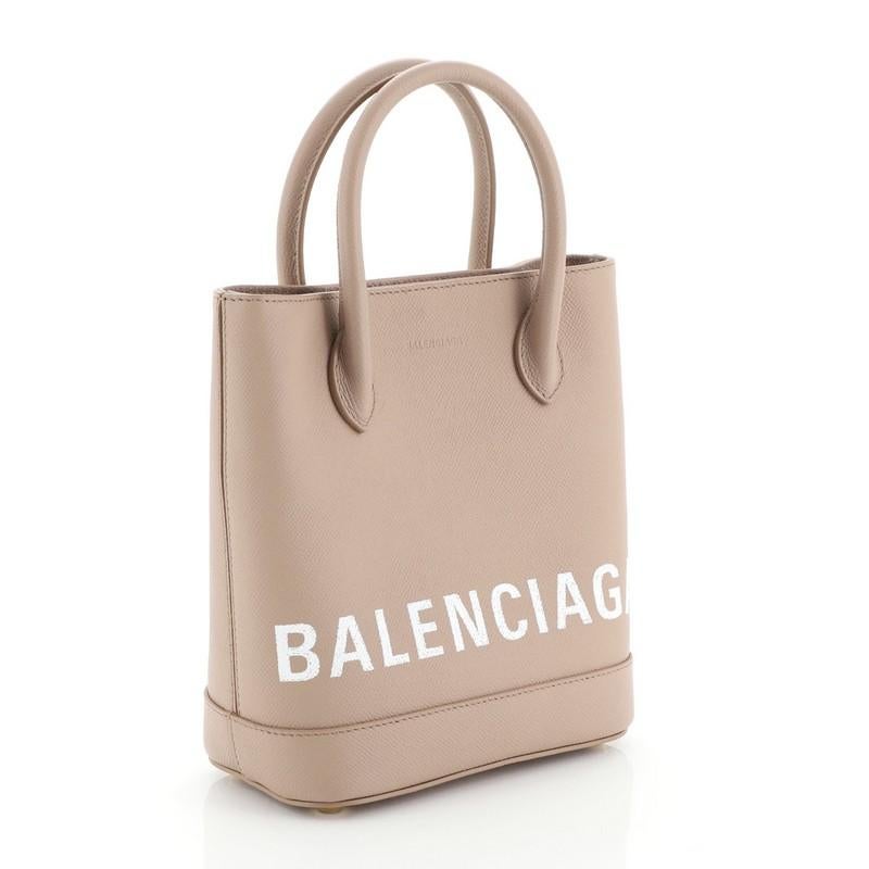 This Balenciaga Logo Ville Tote Leather XXS is a chic piece introduced in the Summer 2018, necessary to stay on the cutting edge. Crafted from pink leather, it features dual rolled leather handles, protective base studs, and gold-tone hardware. Its