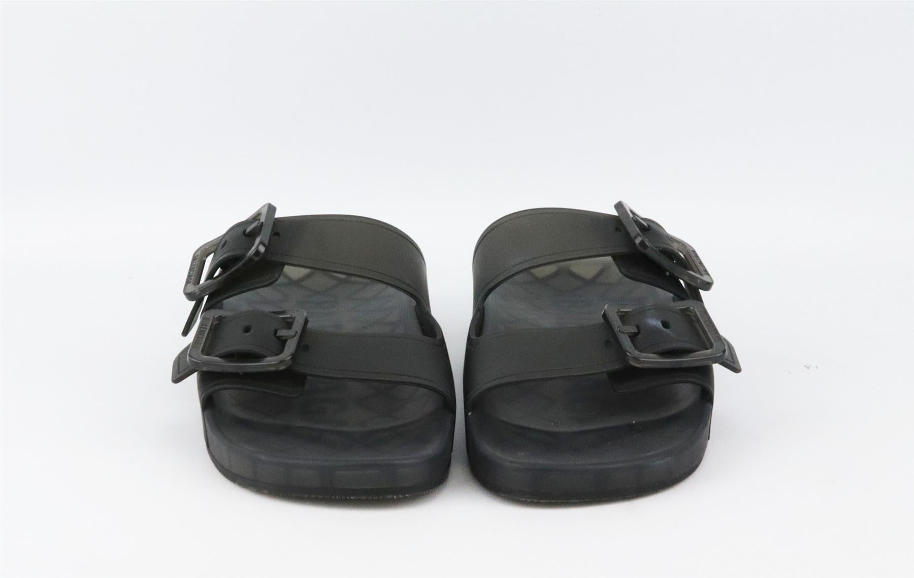 The Balenciaga slides are topped with buckles, they've been made in Italy from black rubber and have comfortable molded footbeds and thick soles. Sole measures approximately 15mm/ 0.5 inches. Black rubber. Slip on. Does not come with box or dustbag.