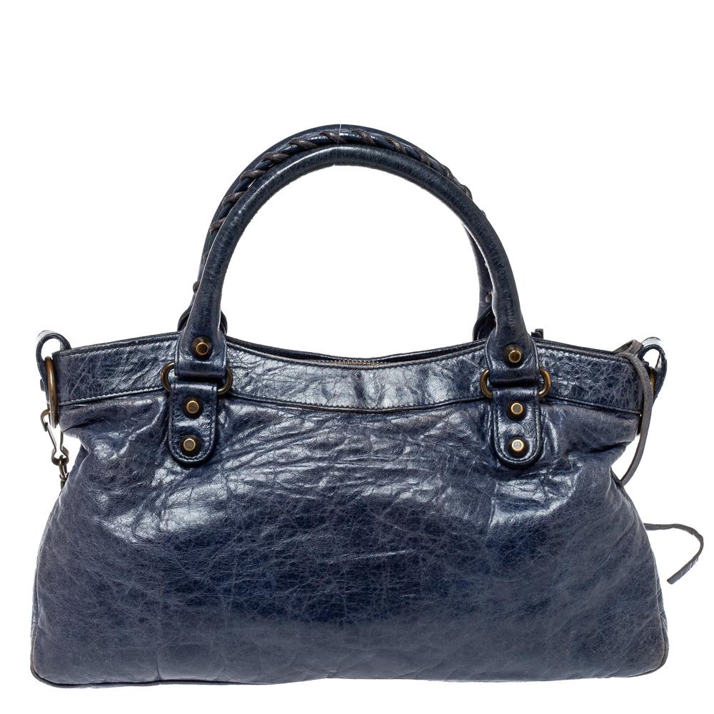 Get your hands on this beautiful leather bag to complete your work-week look. This dressy bag has an interior lined with fabric, two top handles, and a detachable shoulder strap. This Balenciaga bag is much sought after by the fashion-conscious.