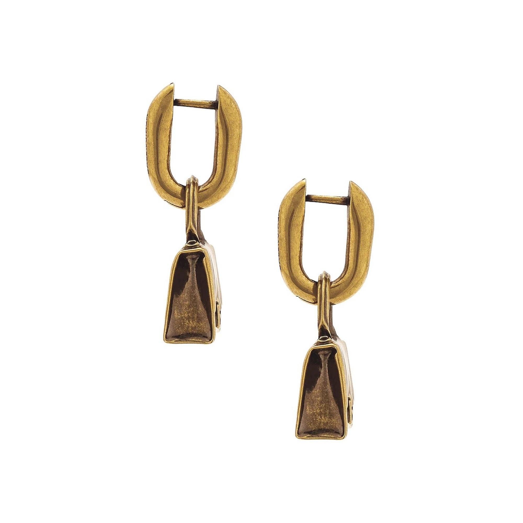 Antique gold-tone earrings from Balenciaga. Crafted from a brass and bronze alloy, this pair features iconic ‘Hourglass’ bag charms.

Color: Antique Gold tone
Material: 80% Bronze, 20% Brass
Marks: Balenciaga Made In Italy
Clasp Style: For pierced