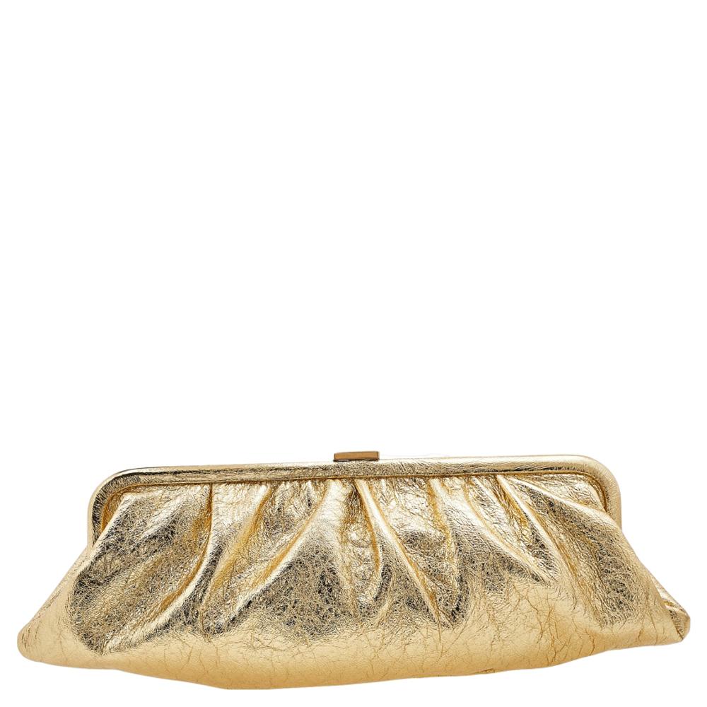 This Balenciaga Cloud clutch stands out with its elongated shape. It has been crafted from gold-hued leather and is a fine choice for evenings. It has a ruched style, front logo detail, fabric interior, and gold-tone hardware.

Includes: Original