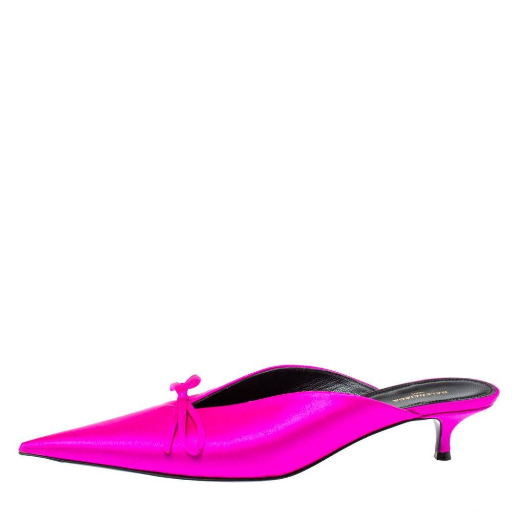 If you are an admirer of the latest fashion trends, this pair of Balenciaga mules will add just the right vibe to your closet. The pointed-toe sandals are covered in metallic pink satin and detailed with subtle bows on the vamps. They are elevated