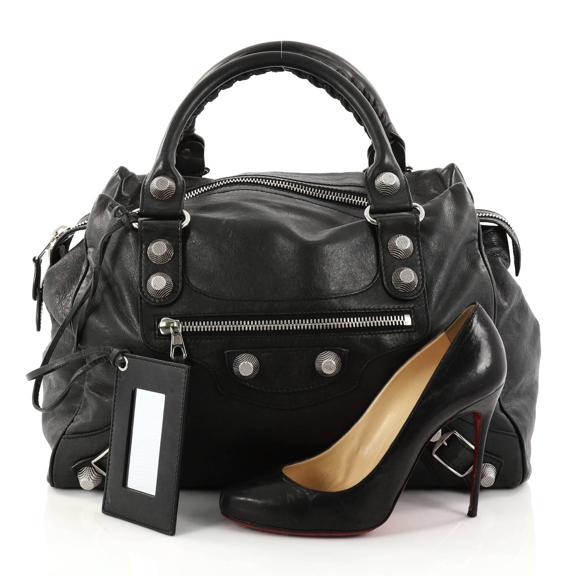 This authentic Balenciaga Midday Giant Studs Handbag Leather is perfect for on-the-go moments. Crafted from black leather, this modern satchel features dual-rolled braided top handles with whipstitch details, exterior front zip pocket, Balenciaga