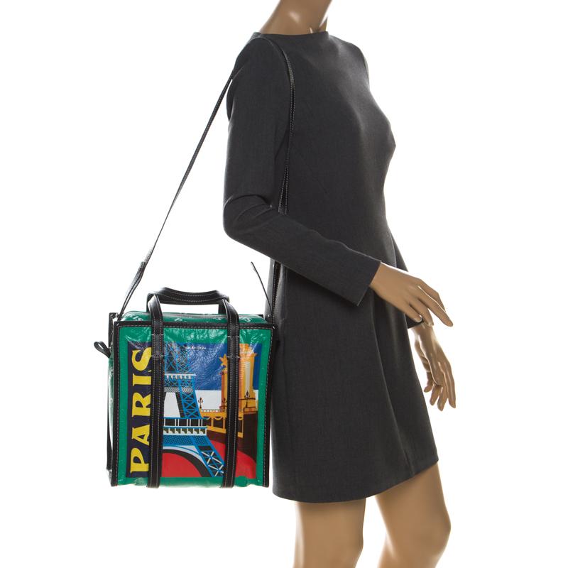 Balenciaga gives a luxurious touch to our everyday errand partner, the shopping bag via this large creation. Made from leather, the bag has a colourful Paris print all over, black leather trims and handles, all very cleverly assembled to look the