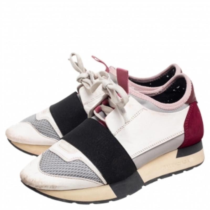 Let your latest shoe addition be this pair of Balenciaga Race Runners sneakers. These sneakers have been crafted from a blend of quality materials and feature a chic silhouette. They flaunt covered toes, strap detailing on the vamps, and tie-up