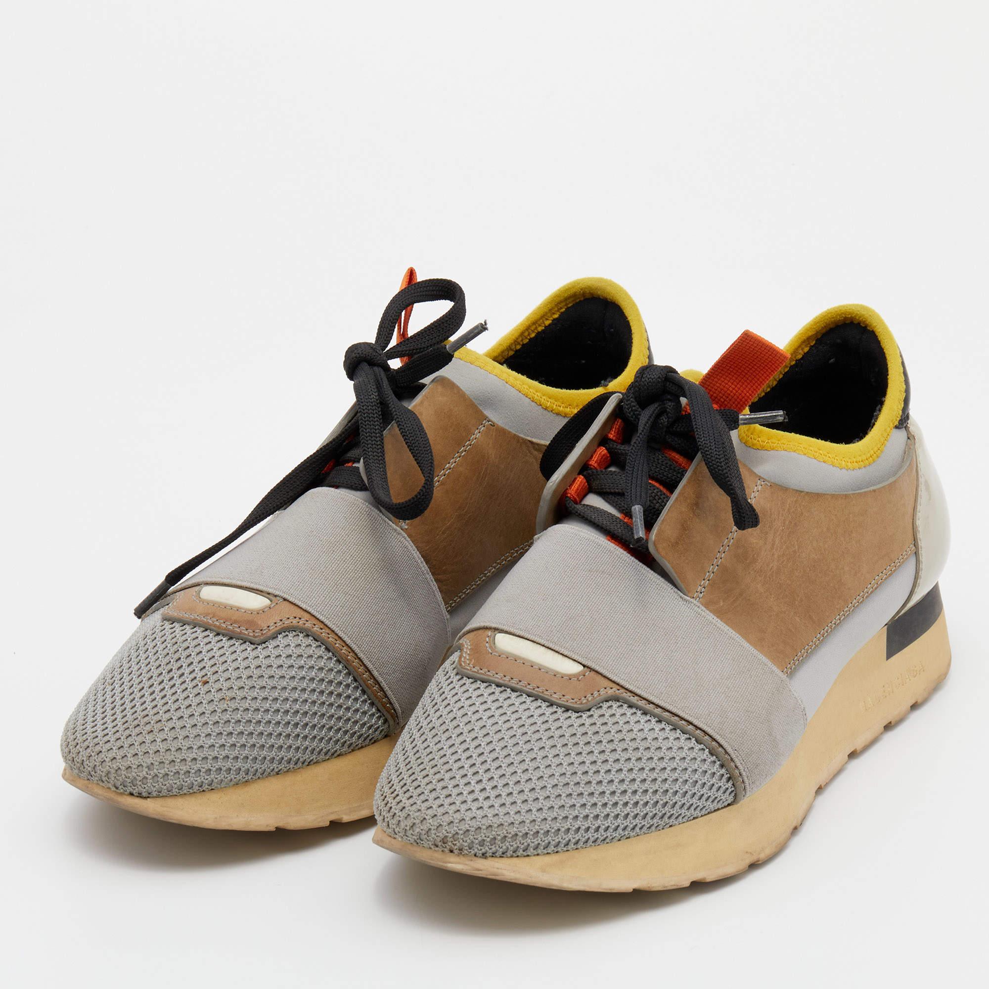 The Balenciaga Race Runner sneakers have been crafted from quality materials and feature a chic silhouette. They flaunt covered toes, strap detailing on the vamps, and tie-up fastenings. They are complete with a leather-lined insole and a tough base