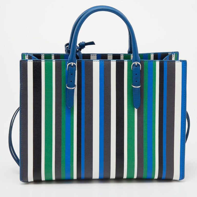 This Papier A6 bag from Balenciaga smoothly blends luxury with practical fashion. It comes crafted from striped leather and styled with two top handles, a spacious leather interior, and a detachable strap. The front is detailed with a signature