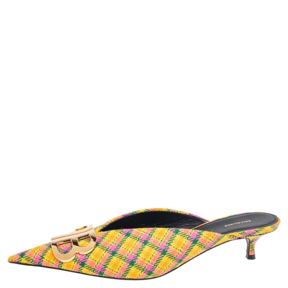 If you are an admirer of the latest fashion trends, this pair of Balenciaga mules will add just the right vibe to your closet. The pointed-toe tweed mules are covered in stunning hues and detailed with the BB metal symbol on the uppers and elevated