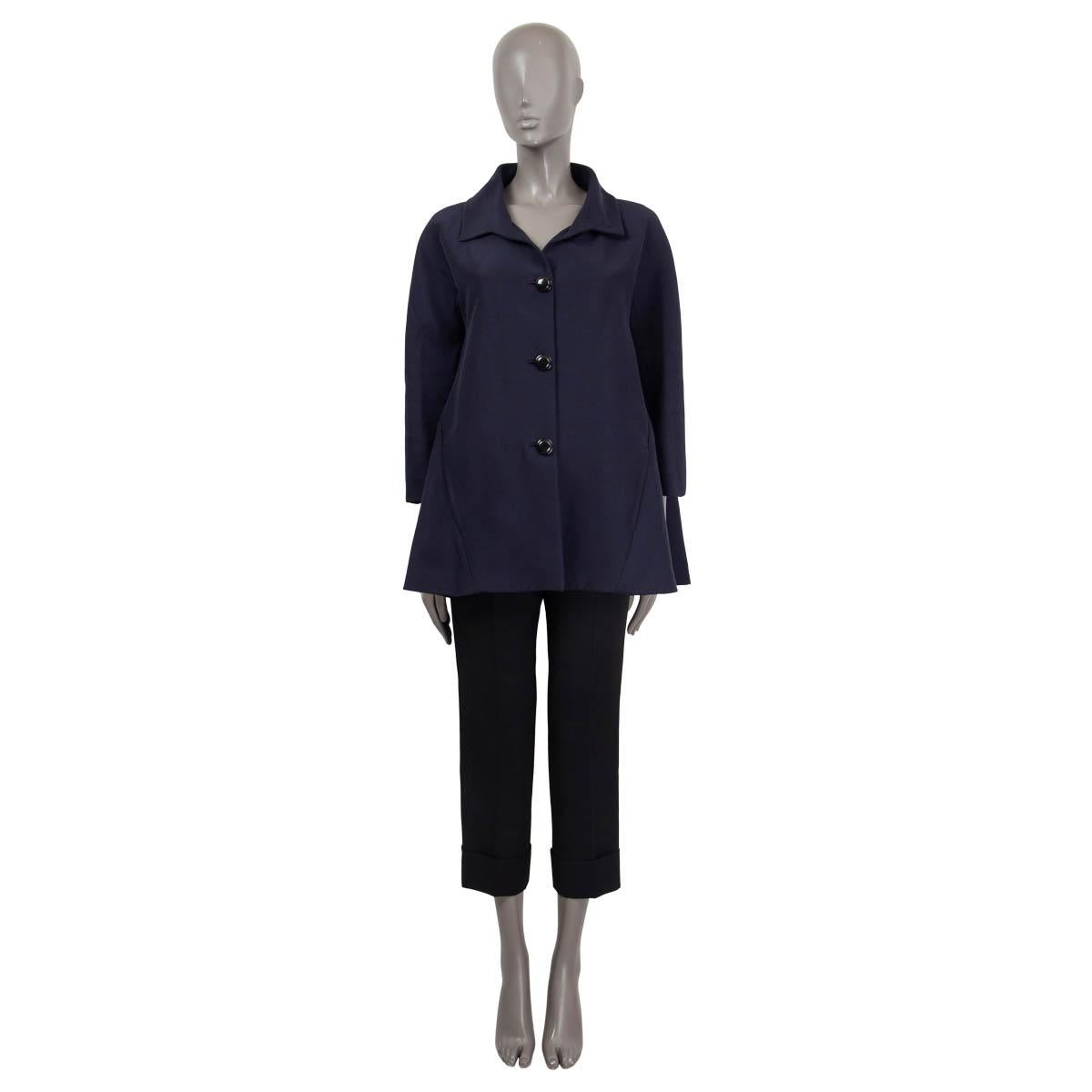 100% authentic Balenciaga a-line jacket in navy cotton (54%) and silk (46%). Features 3/4 raglan sleeves (seeve measurements taken from the neck) and two side slit pockets. Opens with three big black buttons on the front. Lined in blue silk (100%).