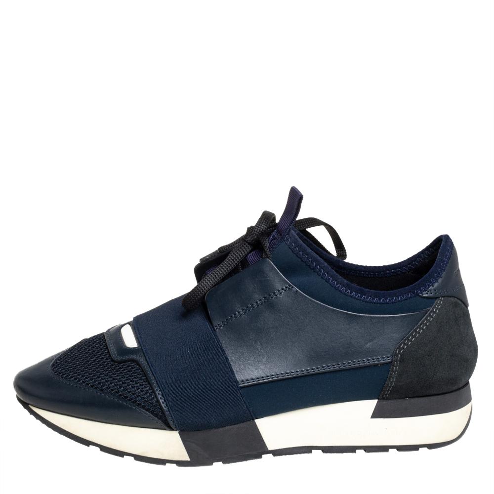 Let your latest shoe addition be this pair of Race Runners sneakers from Balenciaga. These navy blue sneakers have been crafted from leather and mesh feature a chic silhouette. They flaunt covered toes, strap detailing on the vamps, and tie-up