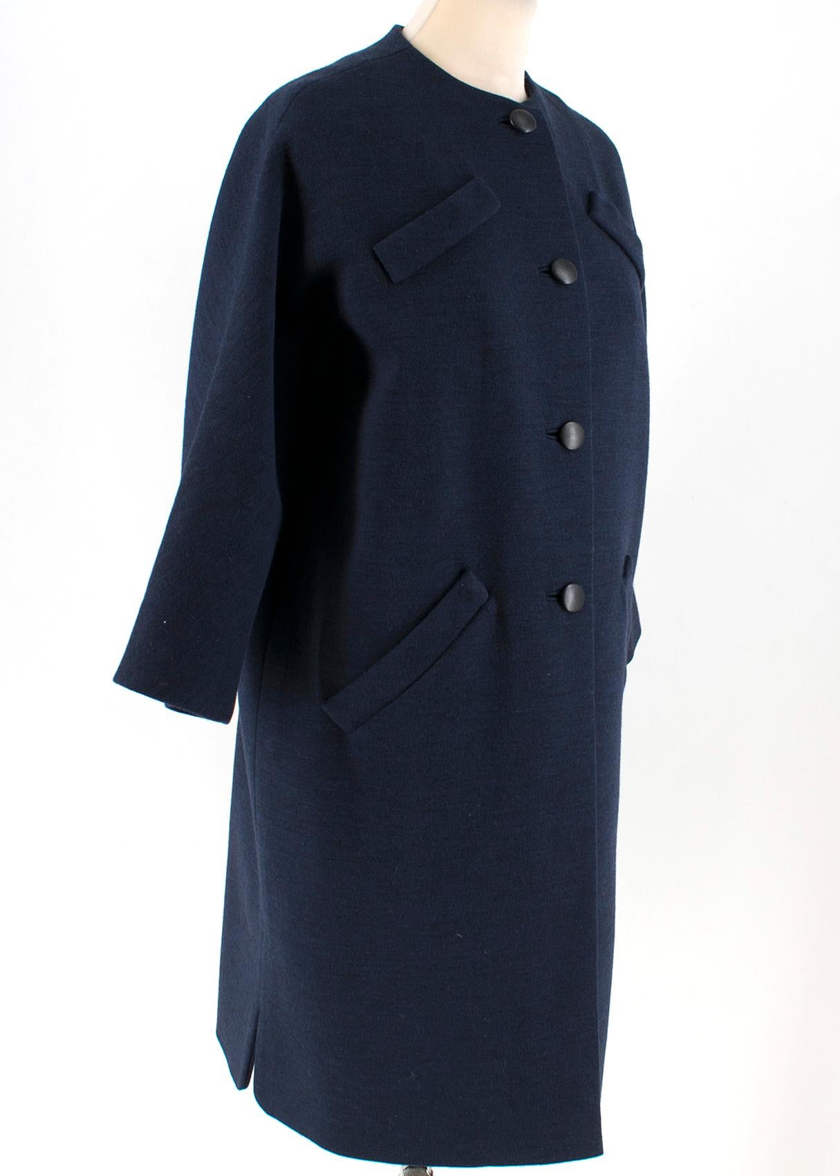 Balenciaga Navy Blue Wool Single-Breasted Coat

- Navy blue, wool coat
- Single-breasted black button fastening closure
- 3/4 sleeves
- Back vent
- Decorative buttoned strap at back
- Decorative stitch flaps at chest

Please note, these items are