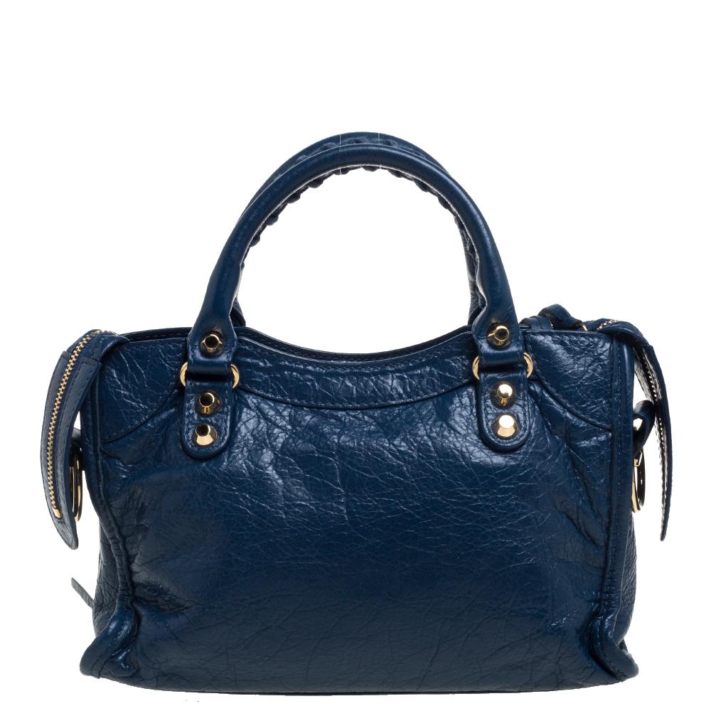 Balenciaga is known for their finely made products and the City bags are one of them. Effortless and stylish, this leather bag will be your go-to for multiple occasions. It has the signature details of buckles, studs, and the front zipper. Two top