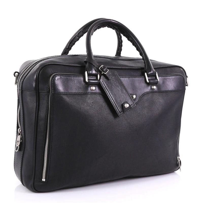 This Balenciaga Neo Folder Briefcase Leather, crafted from black leather, features dual rolled handles, front zip pocket, and silver-tone hardware. Its top zip closure opens to a black fabric interior with slip pockets. 

Estimated Retail Price: