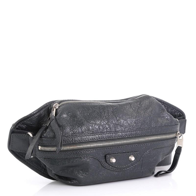 This Balenciaga Neo Lift Classic Studs Waist Bag Leather, crafted in gray leather, features an adjustable waist strap, classic studs detail, front zip pocket and matte silver-tone hardware. Its top zip closure opens to a blue fabric interior.