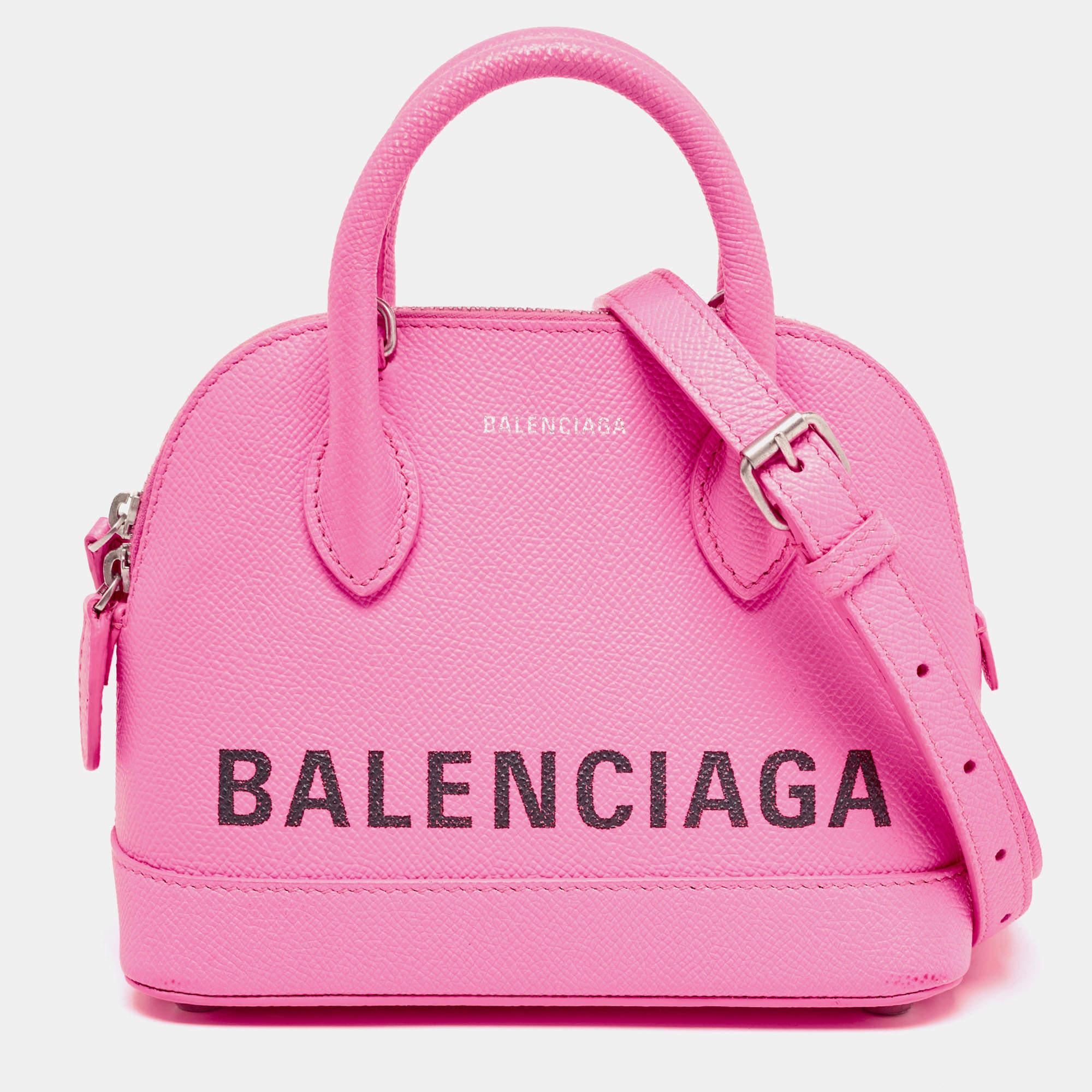 Defined by the signature on its exterior, Balenciaga's XXS Ville satchel is an everyday showstopper. Shaped in a compact size, the silver-tone hardware and branding in black offer a luxurious contrast to the red leather. Secure the zip top all the