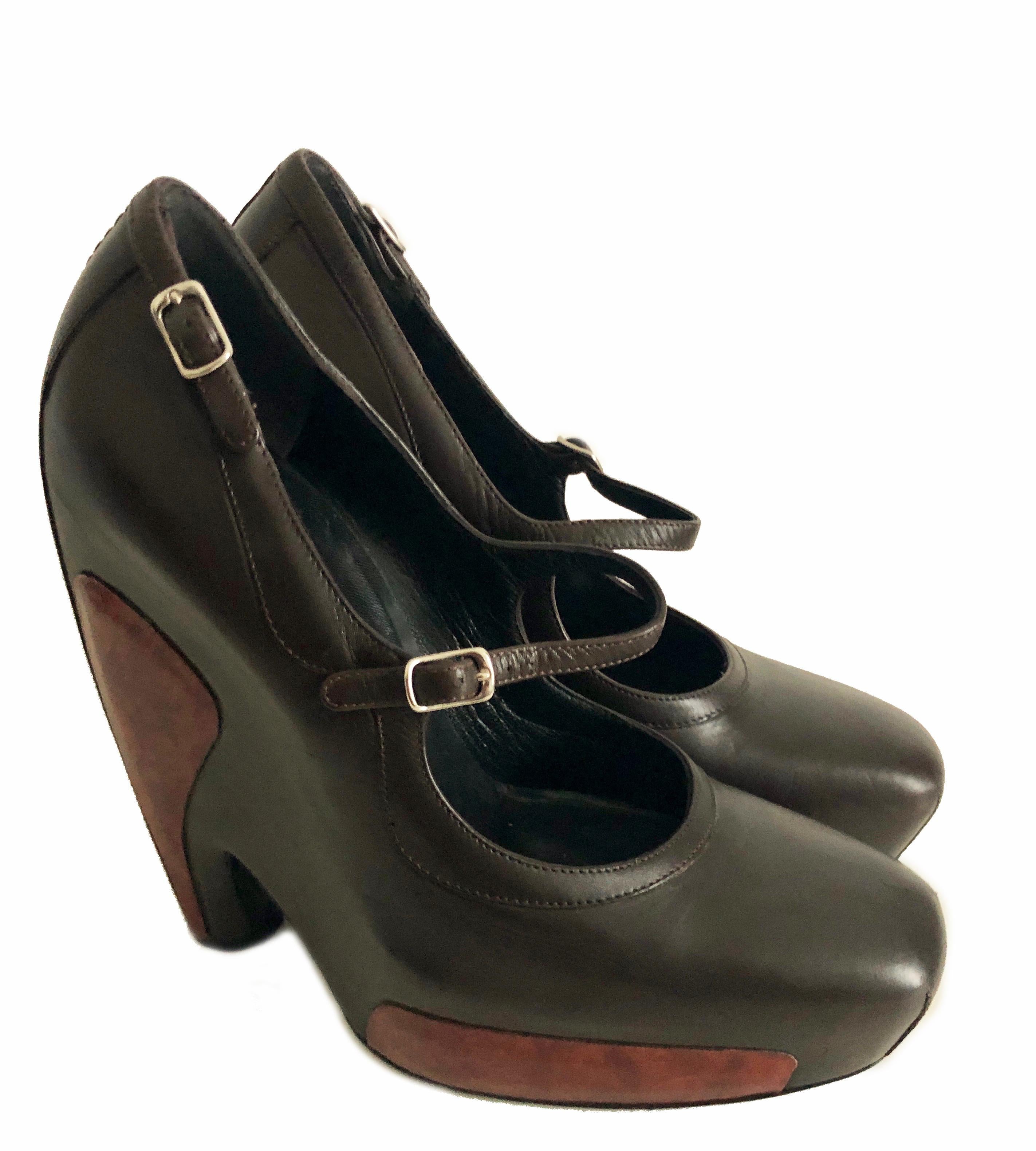 Iconic Balenciaga Mary Jane Brown Leather Platforms with Wood Inserts F/W 2006 by Nicolas Ghesquière.  Tagged size 38, with heels measuring appx 6in H.  Preowned with signs of prior wear to soles, some indentations/light scuffs to leather, some