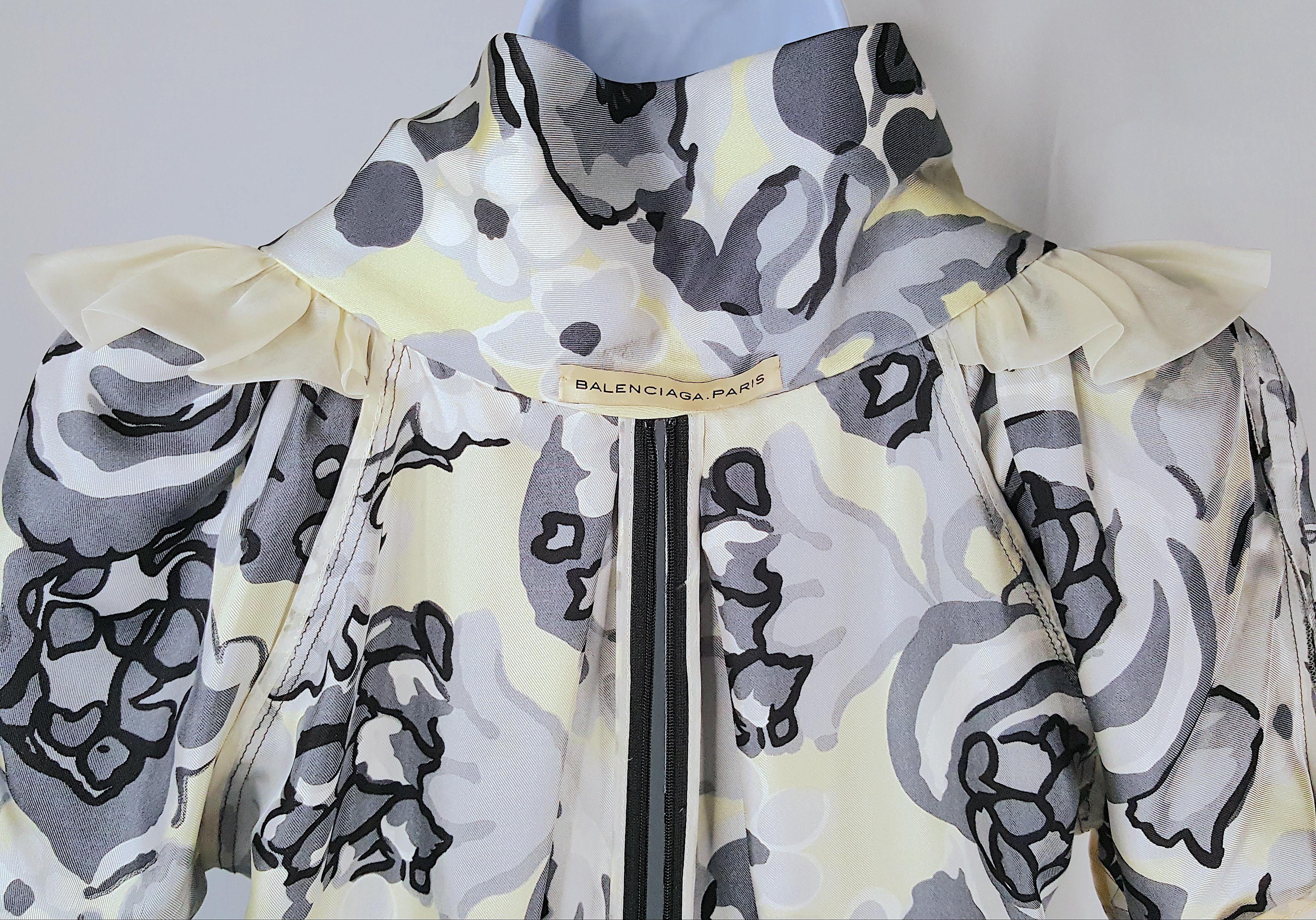While at Balenciaga in late 2007, Nicolas Ghesquiere designed this 100%-silk bias-cut paneled dress that explodes with a grey and pale-yellow flower print and features unique technically-intricate construction on par with couture. With complex