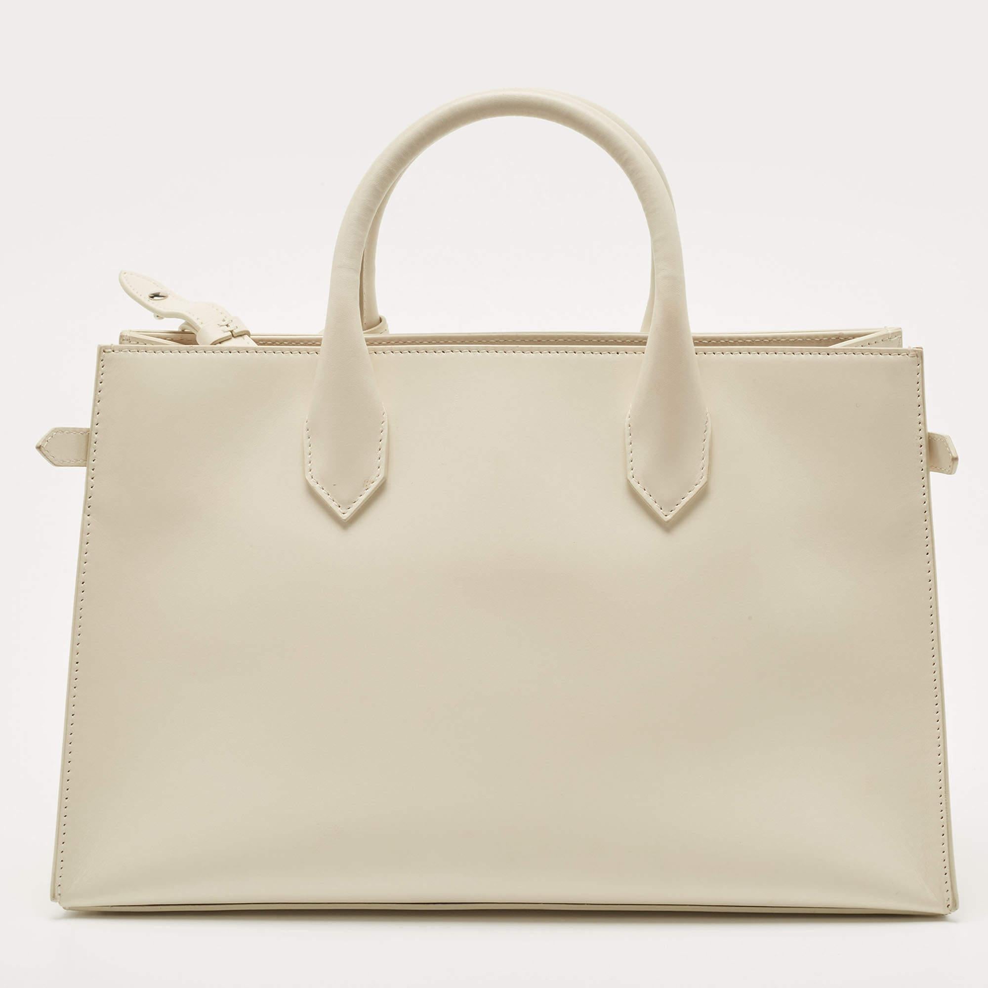 For daily use, this Balenciaga tote for women is ideal. Crafted from leather in a classy shade, the bag has a sleek silhouette with two top handles and silver-tone hardware. It is enhanced with a brand accent on the front.

Includes: Detachable Strap