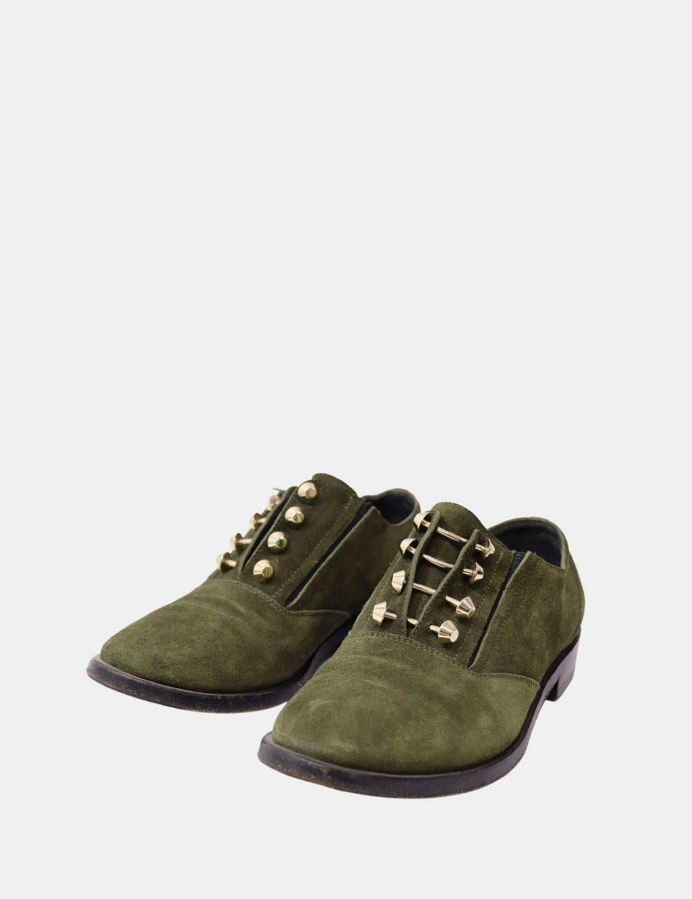 Balenciaga Olive Green Suede Pierced Oxfords, features almond toes, stud embellishments, and slip on style.

Material: Suede
Size: EU 37 
Overall Condition: Good
Interior Condition: Signs of wear
Exterior Condition: Scuffing