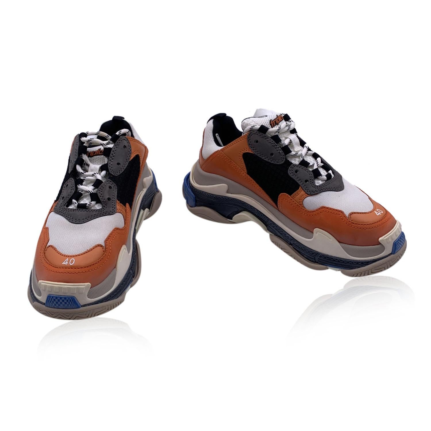 Beautiful Balenciaga 'Triple S' Sneakers. Chunky design. They feature triple layer sole, Balenciaga logo embroidered on the side and on the back, and lace up closure. The size is embroidered on the toes. Imported. Colors: Orange, White, Black, Blue.