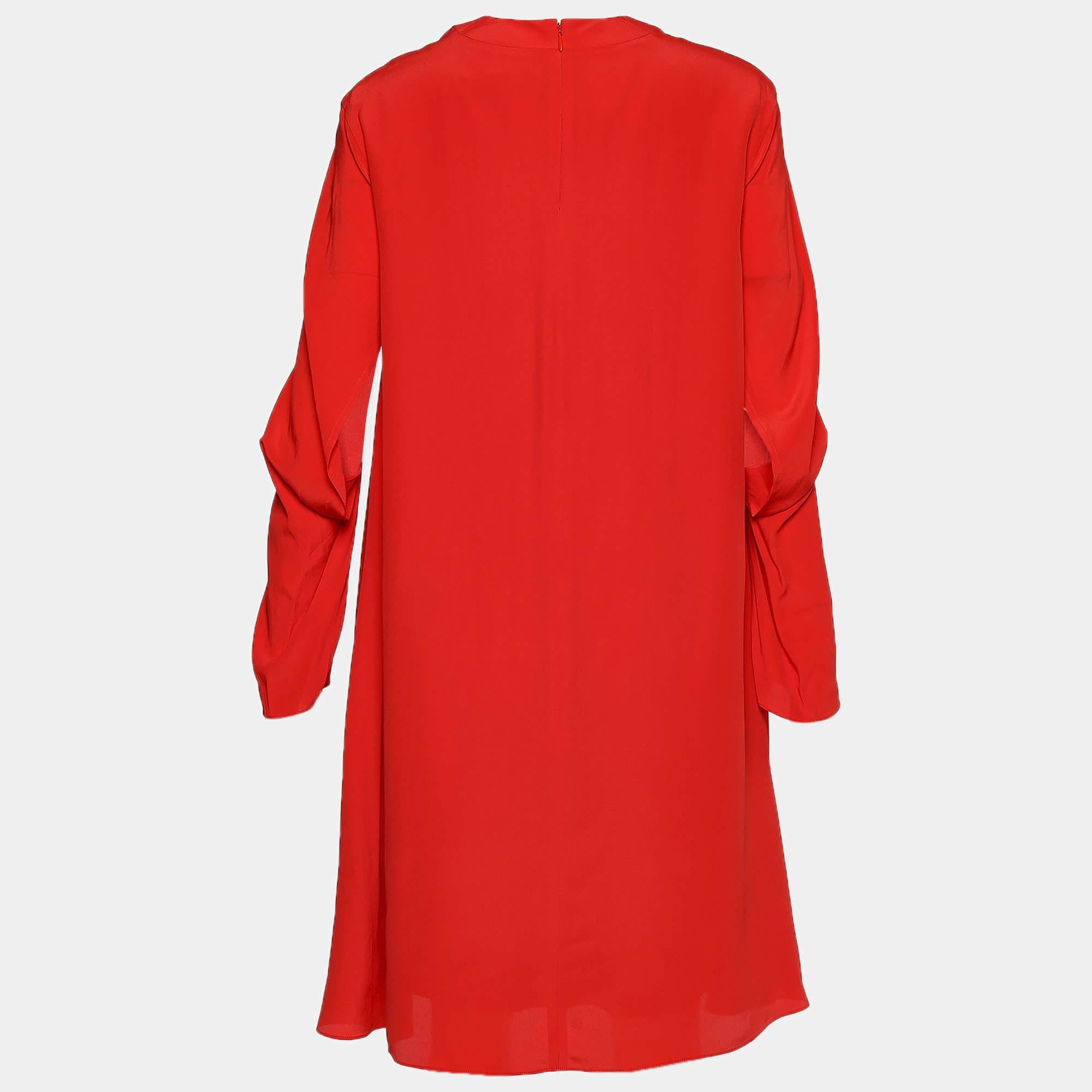 Attractive and classy, this shift dress from the House of Balenciaga will definitely elevate your style factor and make you look chic! It is created using orange crepe fabric into an oversized silhouette. It has long sleeves and a zipper for