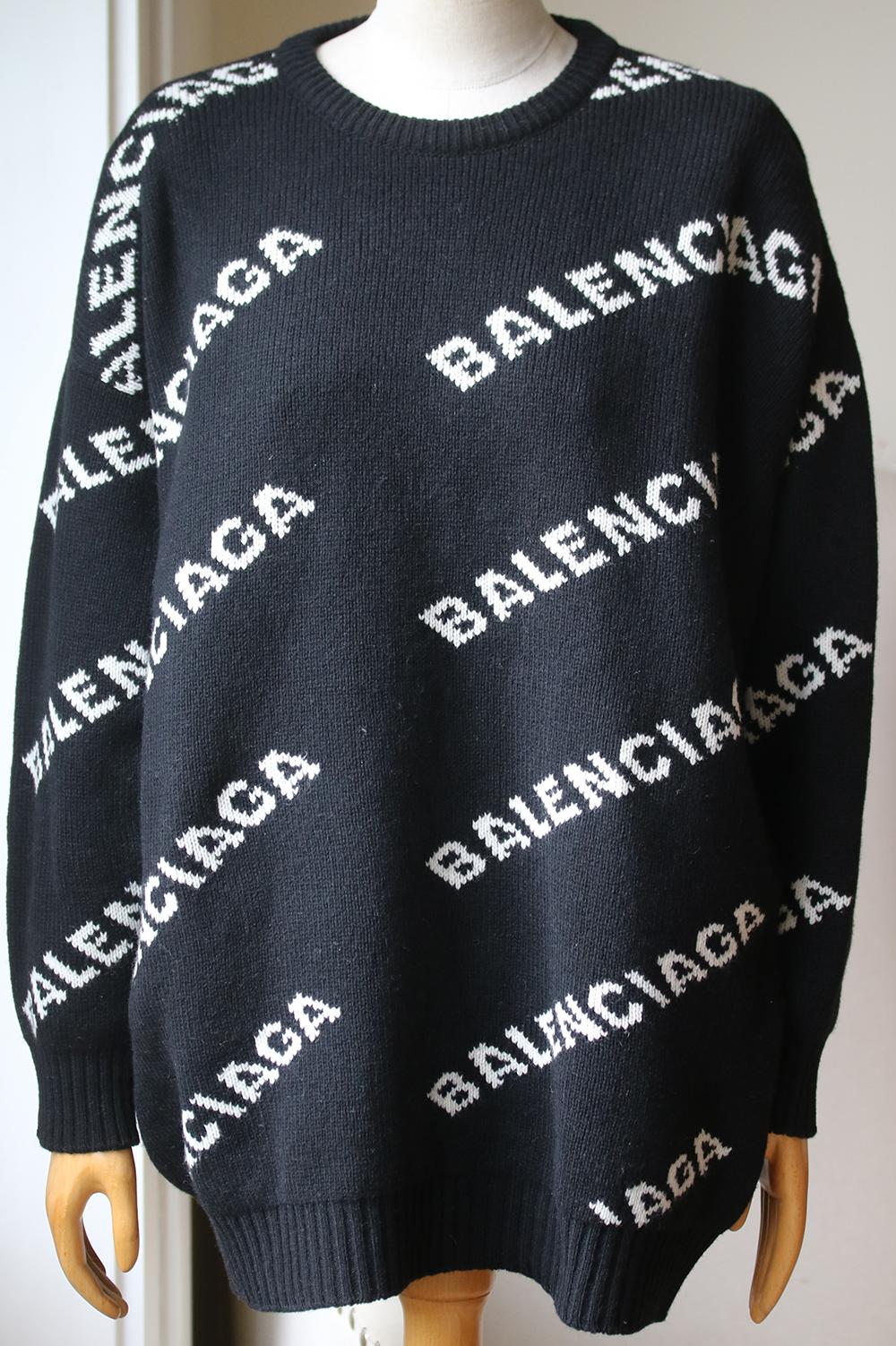 Few designers have embraced the 'Logomania' trend with more fervor than Demna Gvasalia, who has intarsia-knitted 'Balenciaga' diagonally across this chunky sweater. Black and white wool, camel, polyamide and polyester-blend. Slips on. 49% wool, 48%