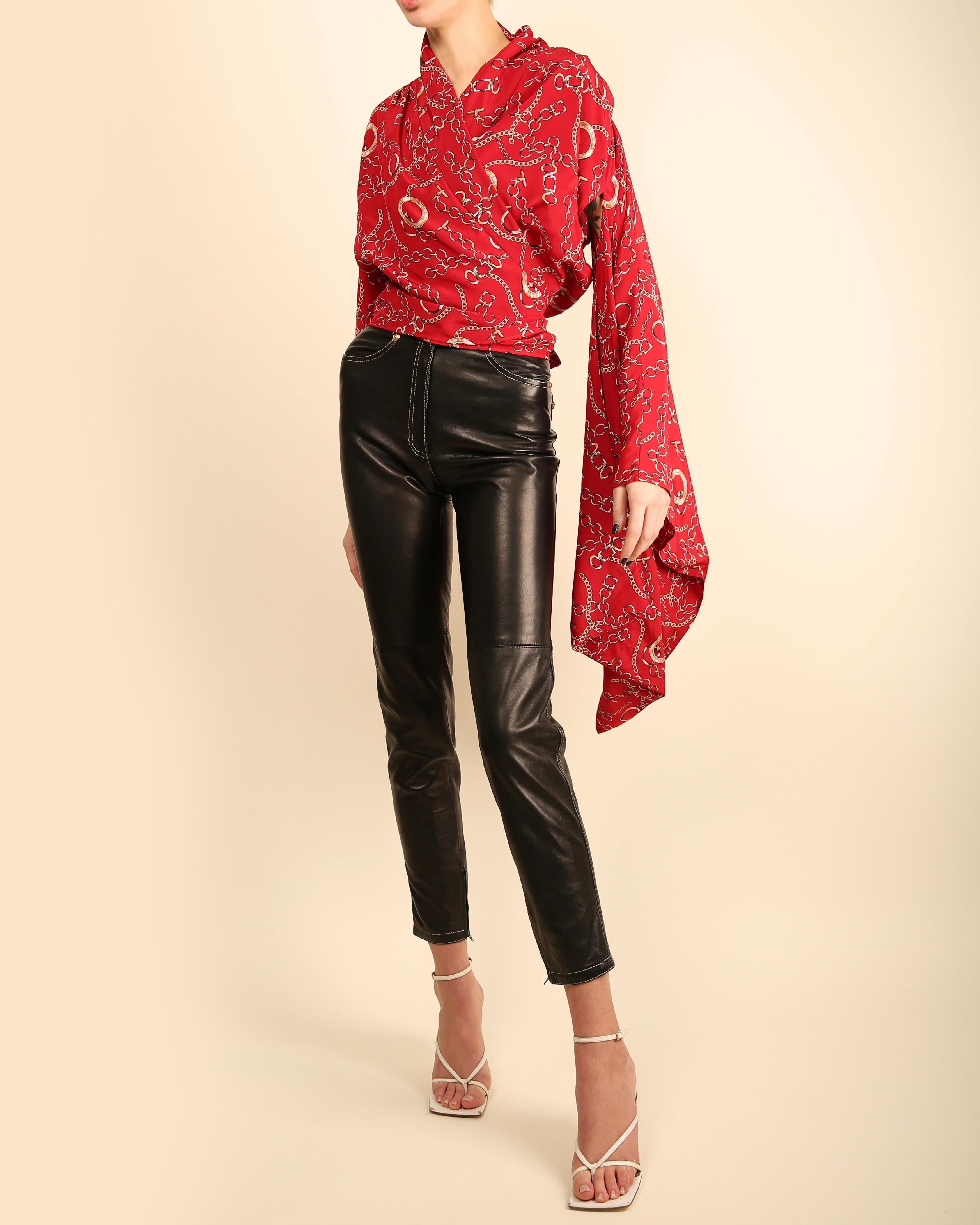 Balenciaga oversized silk blouse in red with gold chain equestrian print
One shoulder has a shoulder pad with a normal sleeve. The other has no shoulder pad and a large oversized kimono sleeve
Wrap closure at waist with long ties
MADE IN