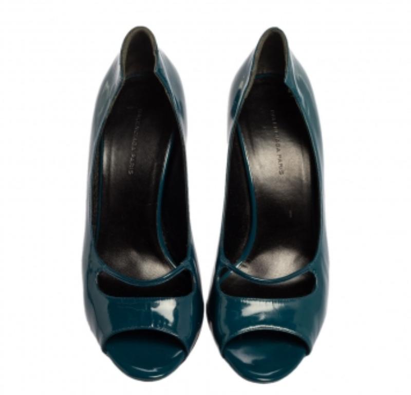 Let these Balenciaga pumps lift you up in style and grab all the admiration! Loverly in peacock blue, they come crafted from patent leather and feature a peep-toe silhouette. They have been detailed with exaggerated counters and endowed with