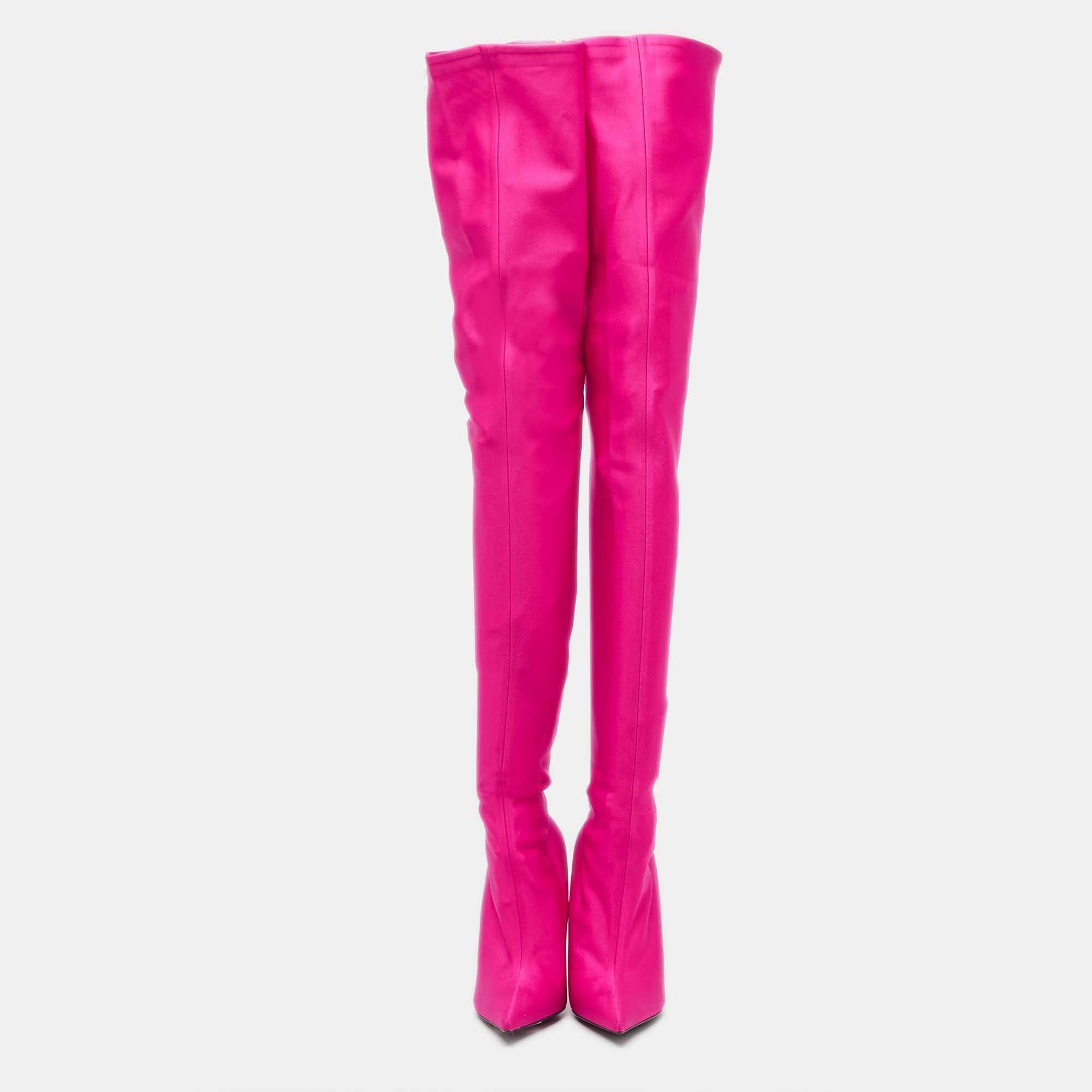 Crafted with finesse, the Balenciaga Knife boots are such a statement pair. The vibrant pink satin gracefully envelops your legs, while the sleek silhouette elongates your frame. With a pointed toe and a slender heel, these boots effortlessly blend