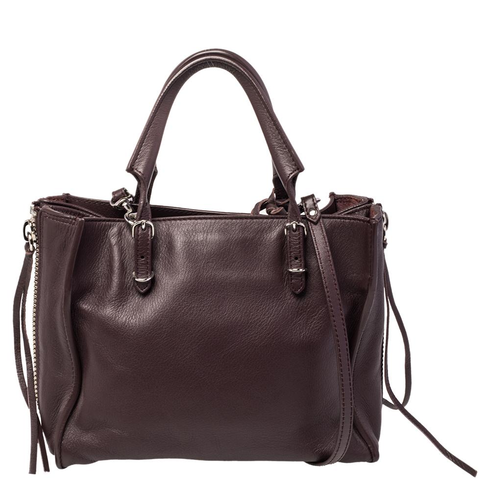 This Papier A4 tote from Balenciaga smoothly blends luxury with practical fashion. It comes crafted from leather and styled with two top handles, a suede interior, and a detachable shoulder strap. But it is the zipper and buckle detailing which