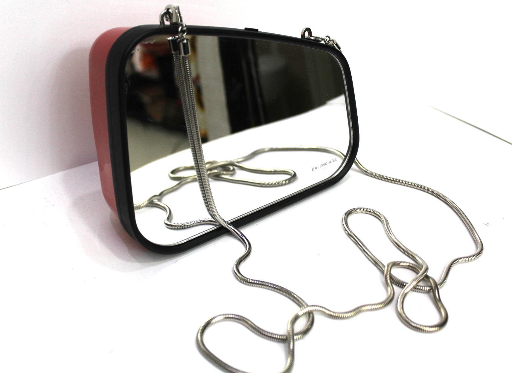 REAR-VIEW MIRROR clutch bag by Balenciaga. This bag has the shape of a car mirror. Opening with button. Equipped with a metal shoulder strap. It is in excellent condition, equipped with a box.