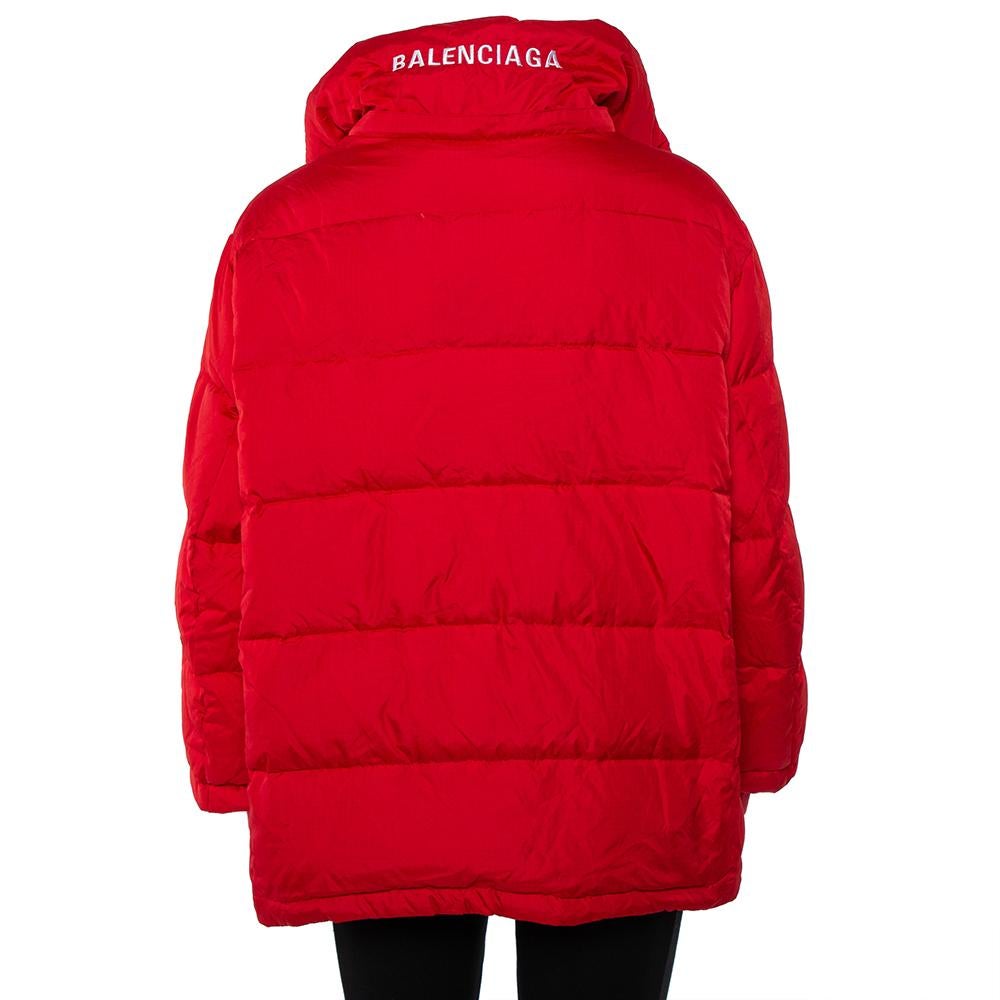 The bright red hue and the quilted puffer style make this Balenciaga jacket a covetable piece. It exhibits a relaxed, comfortable silhouette that adds a cool quotient to the jacket. Equipped with long sleeves and zip-button fastenings, wear this one