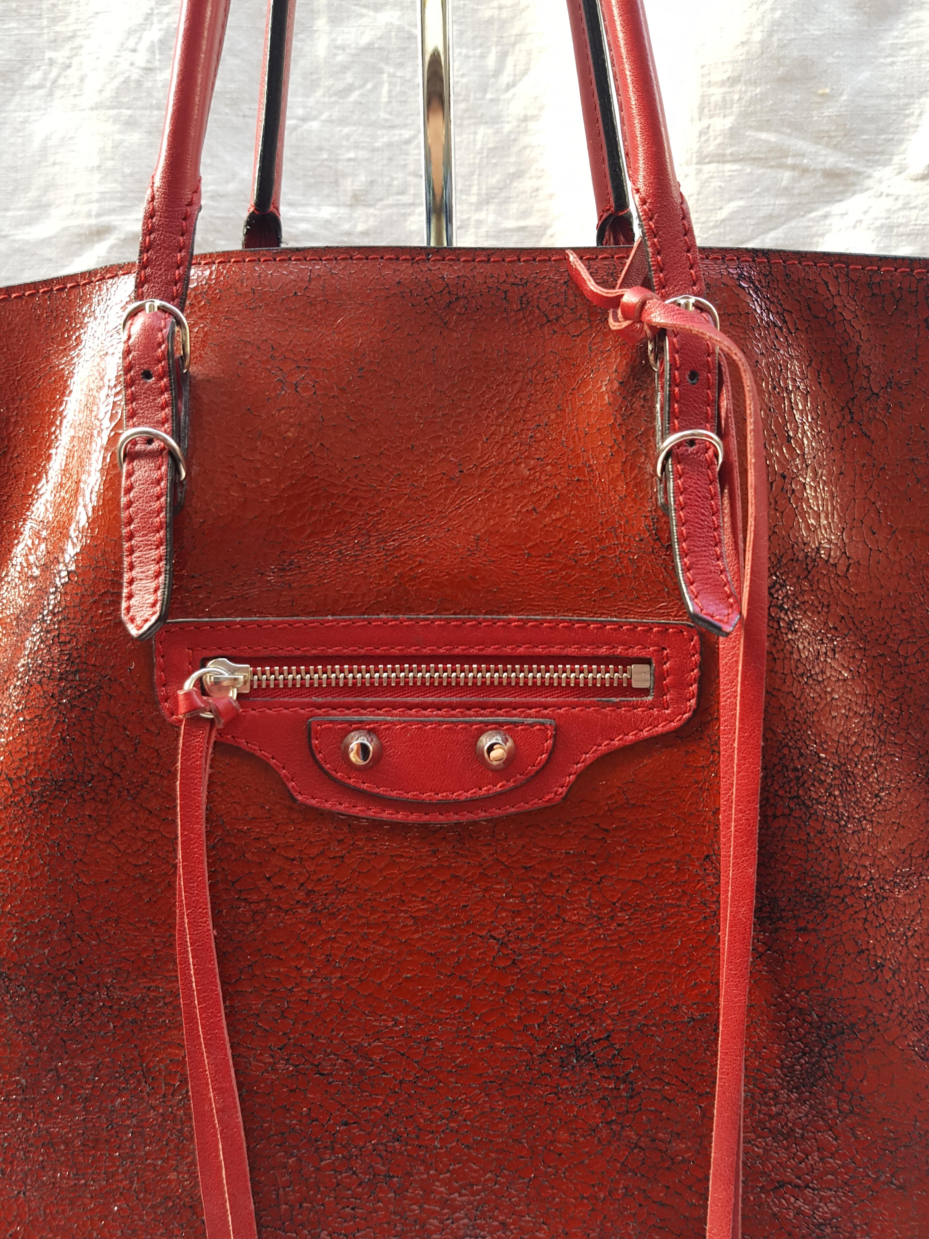 Beautiful Balenciaga Papier A4 tote in textured red leather.

-Classic small mirror on leather tassel
-Brass hardware
-Single exterior zip pocket
-Stud and buckle accents
-Dual slit pockets in interior
-100% Leather
-Circa 1999-2009
-Very good