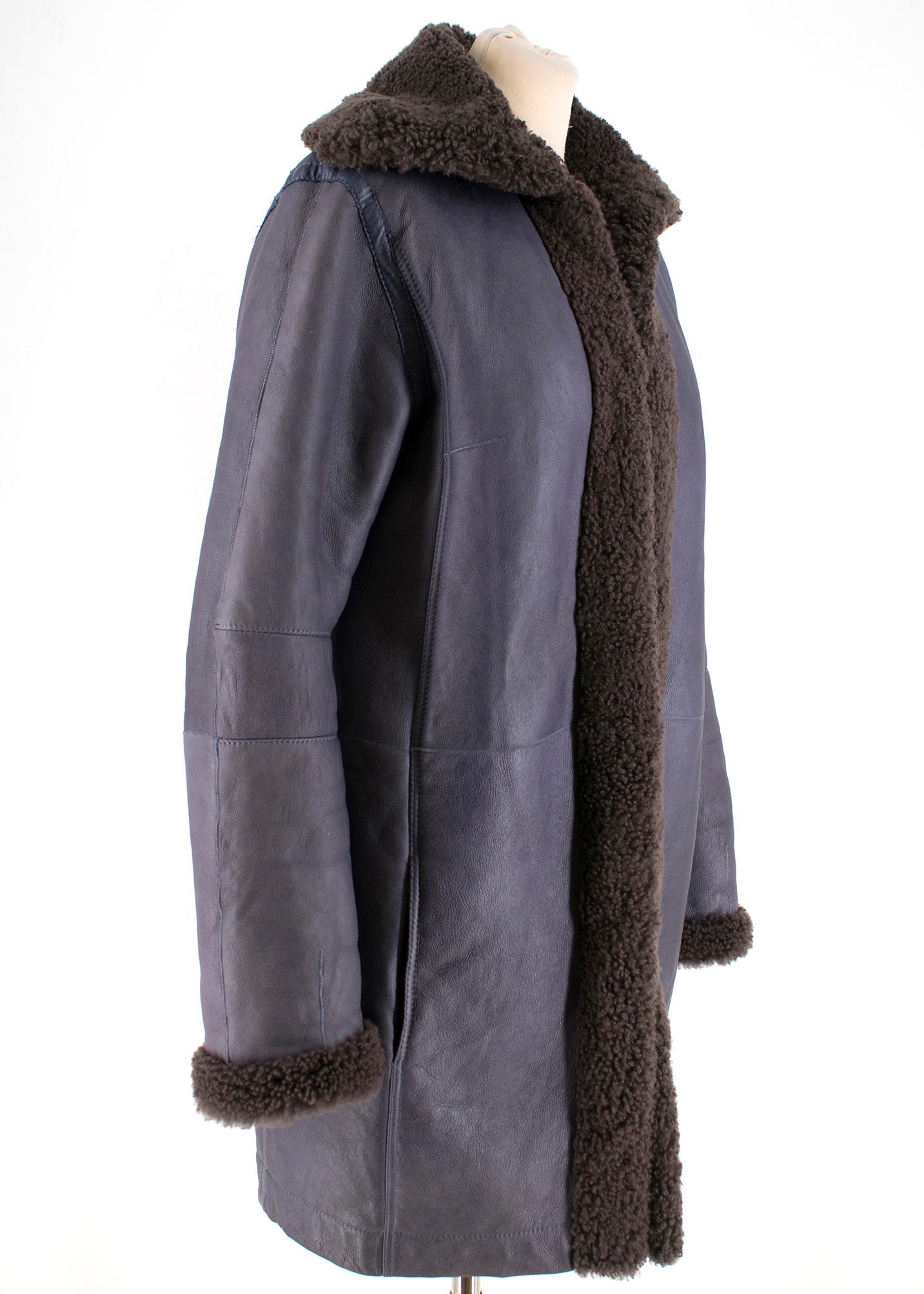 Balenciaga blue mid-length coat with a brown shearling interior and long sleeves. RRP £1650

- Concealed front buttons
- Side pockets
- 100% lamb
- Made in Turkey

Measurements are taken laying flat, seam to seam. 


Shoulders:40cm
Sleeves: