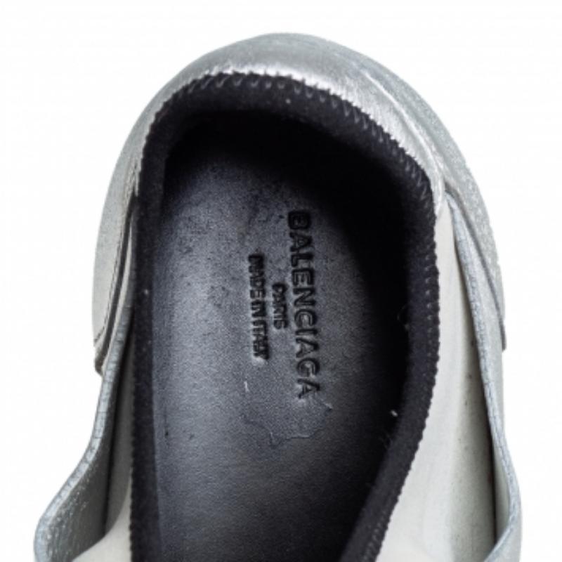 Let your latest sneaker addition be this pair of low-top Race Runners from Balenciaga. These silver sneakers have been crafted from Neoprene, leather, and knit fabric. They feature a chic silhouette, covered toes, strap detailing on the vamps, and